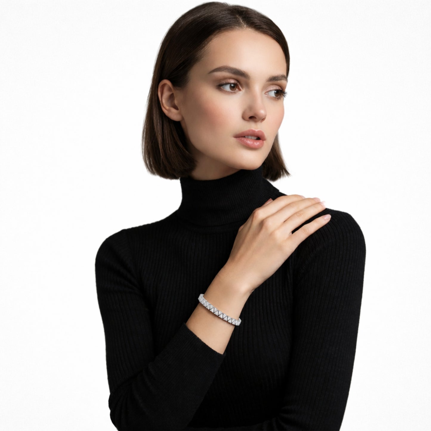 Model view highlights a structured silver tone tennis bracelet built from square cubic zirconia links, stacked over a black ribbed turtleneck for sharp, high-contrast glow.