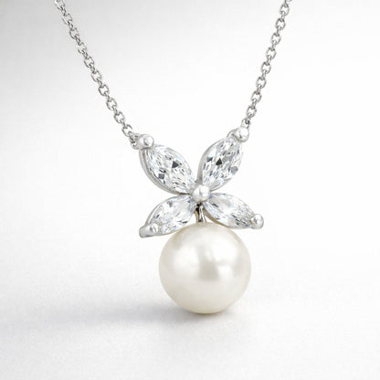 Detail view of the butterfly pendant highlighting the marquise cut cubic zirconia wing design and the smooth round pearl drop.