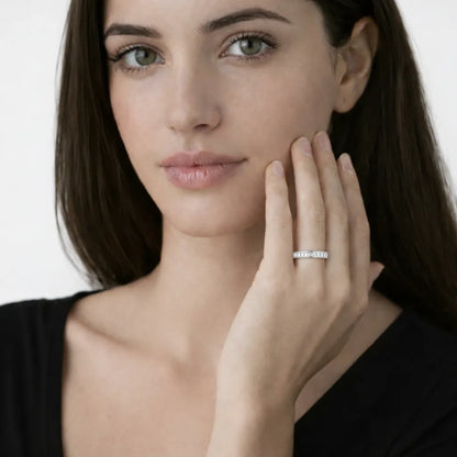 Model view showcases a silver tone channel set baguette cut cubic zirconia ring, styled with a tailored black top so the ring sparkles along the fingertips.
