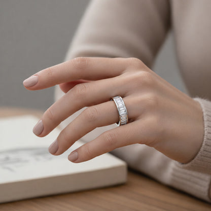 Worn on hand view of a channel set baguette cut cubic zirconia ring in silver tone finish, illustrating proportions and everyday wear appearance.