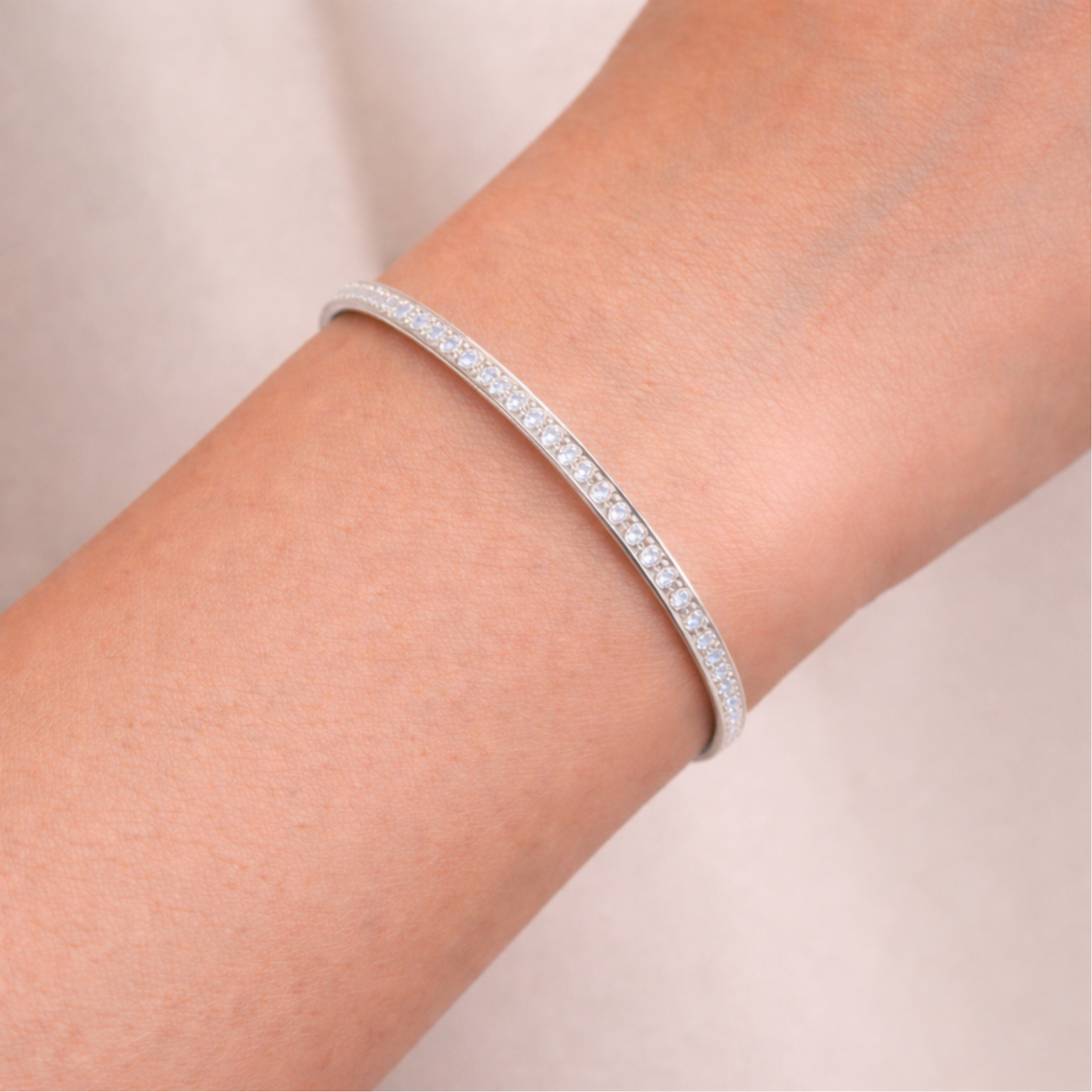 Channel set crystal cuff bracelet worn on the wrist, showing slim profile and elegant fit.
