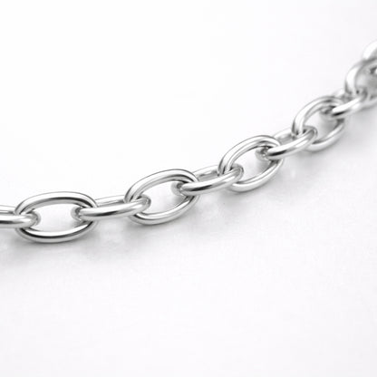 Studio view of a fine cable chain necklace with evenly spaced oval links in a polished silver tone finish.