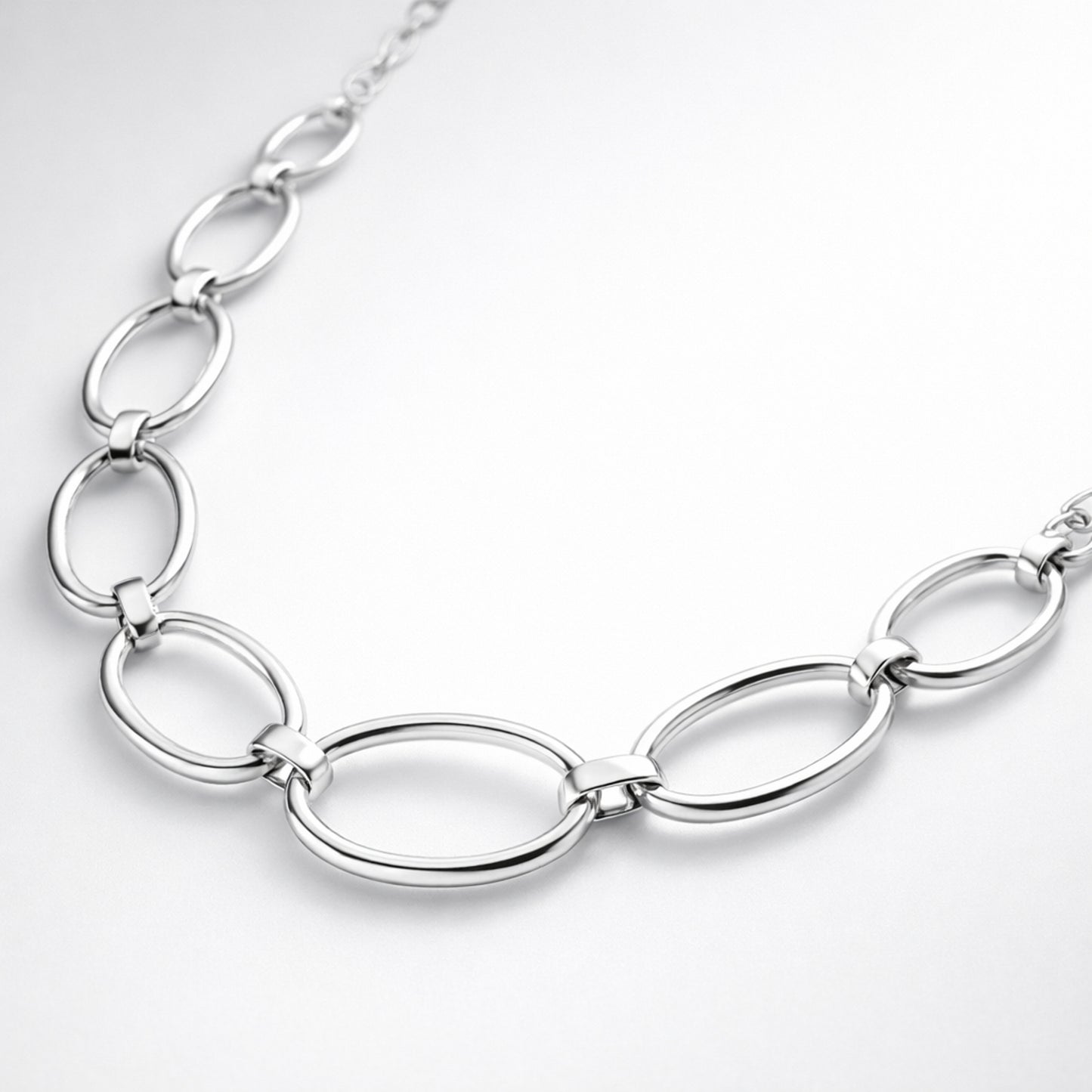 Angled studio view showing the elongated oval links and smooth silver tone finish of the necklace.