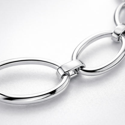 Close up detail highlighting the oval link structure and polished silver tone surface.