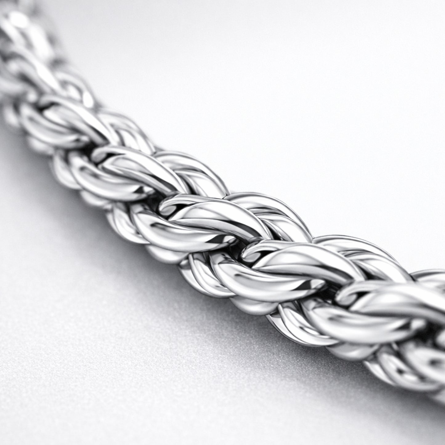 Close up detail of the rope chain highlighting the braided oval link structure and smooth polished silver tone surface.