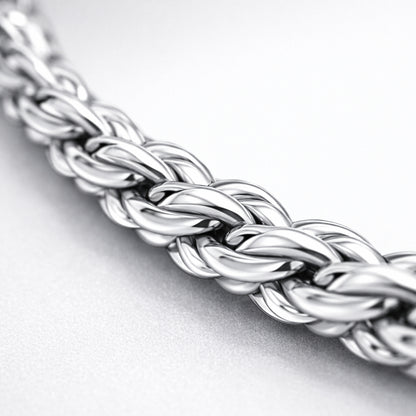 Close up detail of the rope chain highlighting the braided oval link structure and smooth polished silver tone surface.