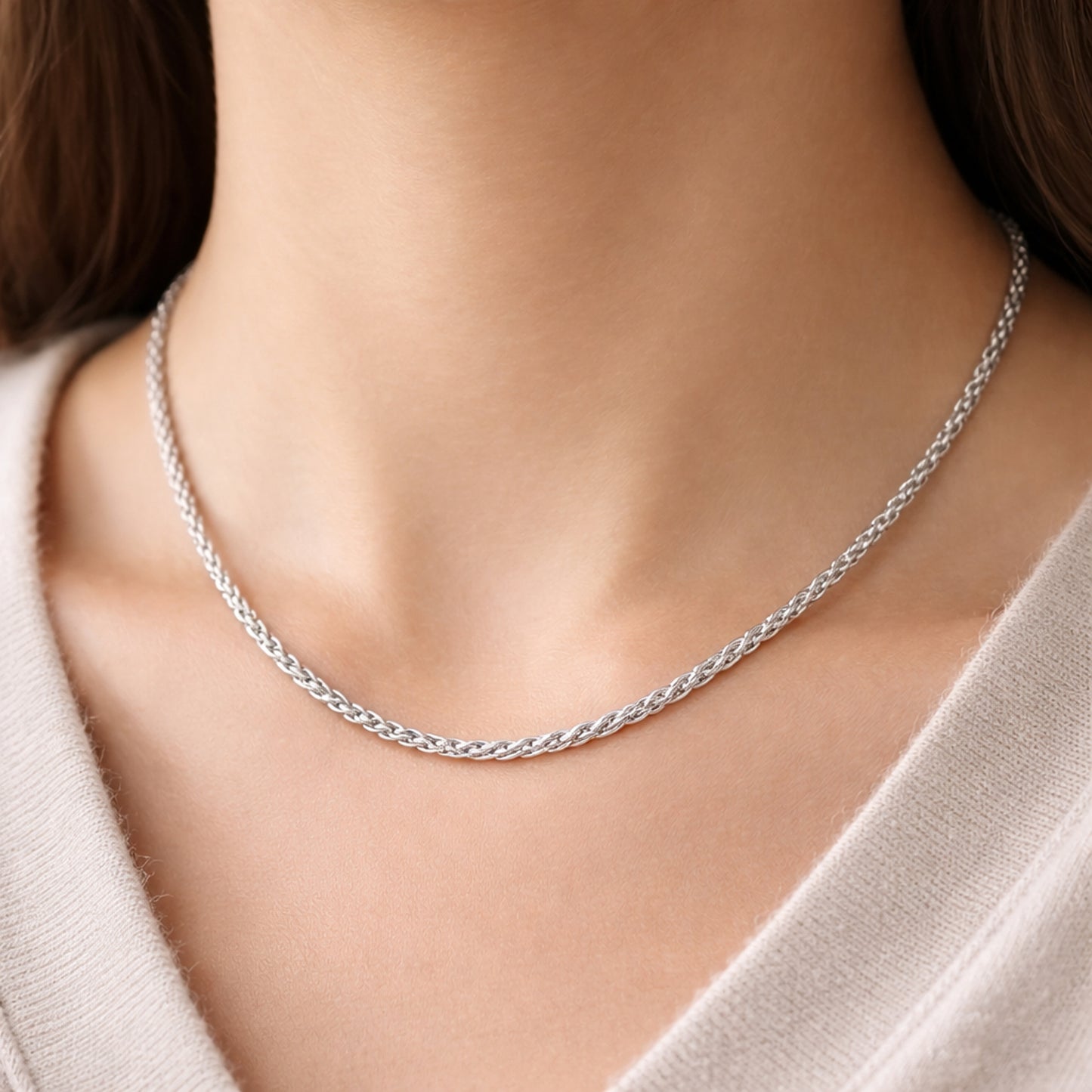 Front view of the rope chain necklace worn on the neck, highlighting the smooth twisted link design and polished silver tone finish.
