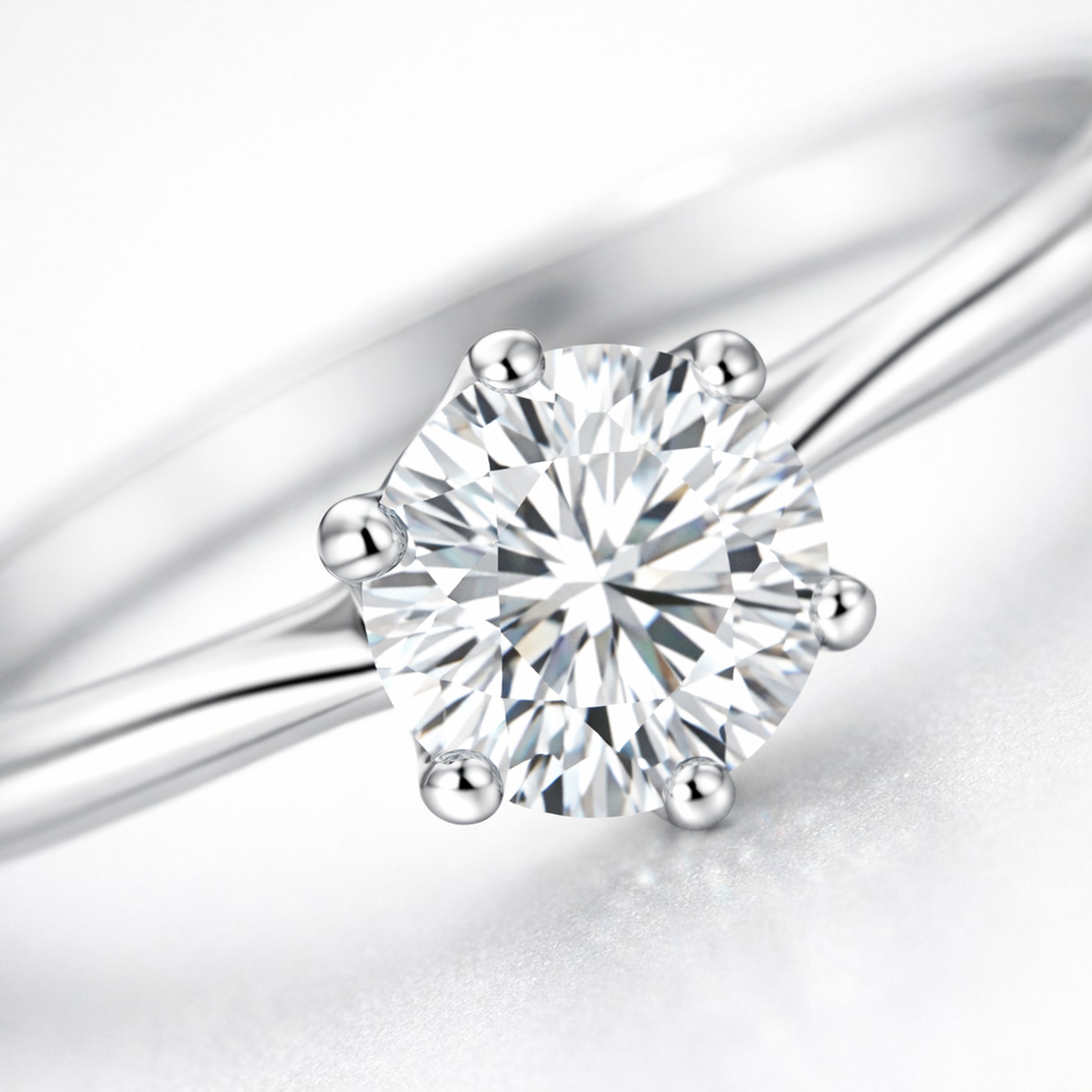 Close up view of the classic solitaire cubic zirconia ring focusing on the faceted round cut stone and the refined prong setting.