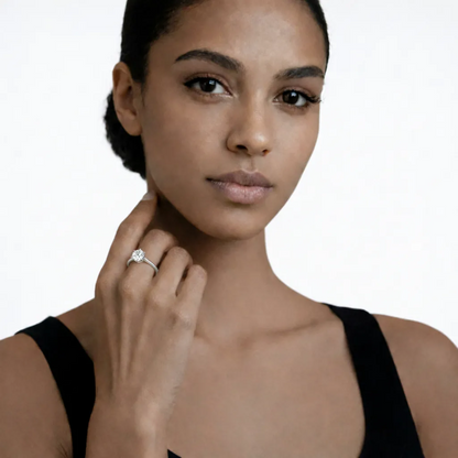 On-model portrait highlights a silver tone classic solitaire cubic zirconia ring, styled with a black sleeveless top so the ring sparkles along the fingertips.