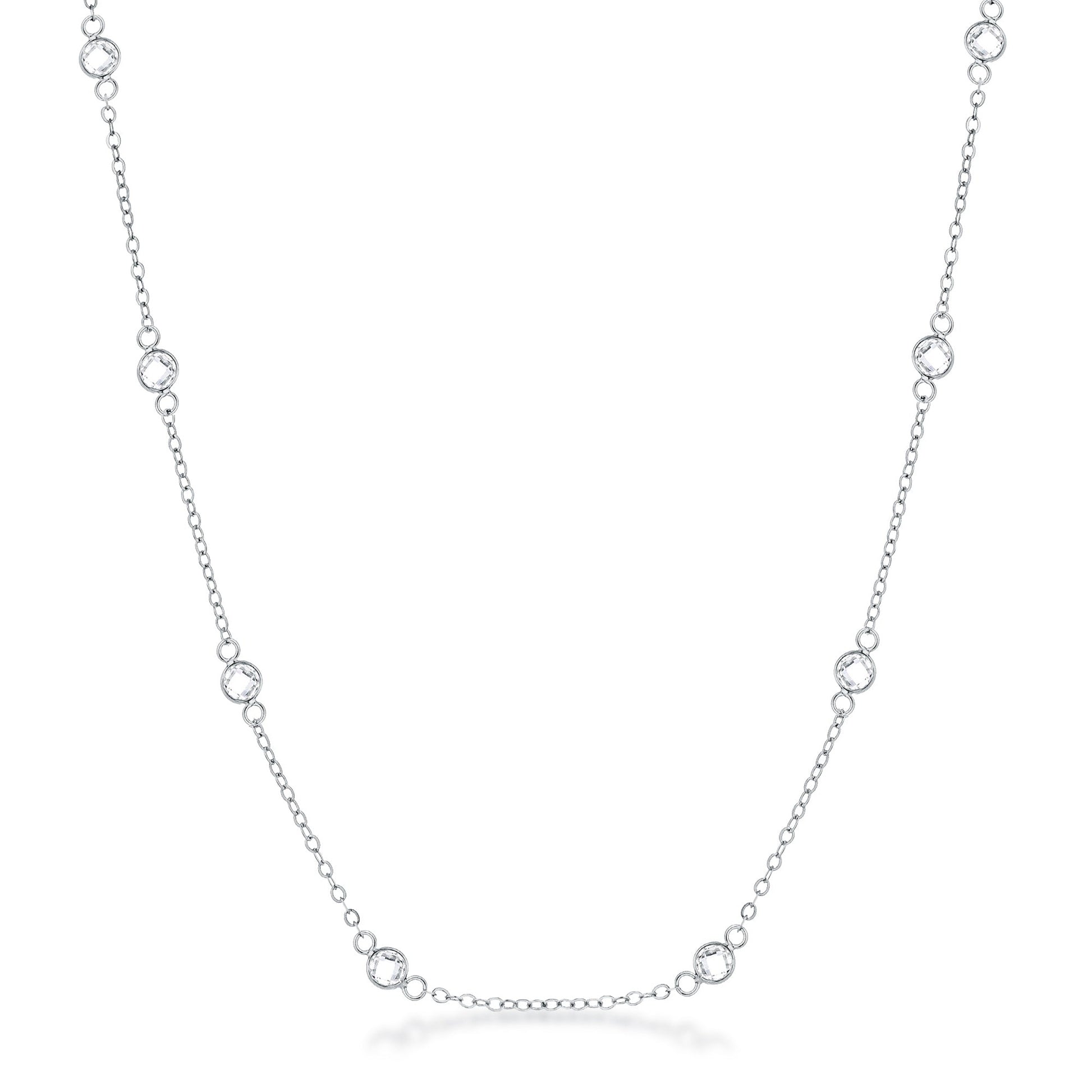 Front facing studio view of a silver tone station necklace featuring evenly spaced bezel set stones along a delicate chain.