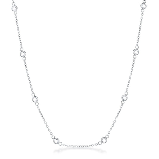 Front facing studio view of a silver tone station necklace featuring evenly spaced bezel set stones along a delicate chain.
