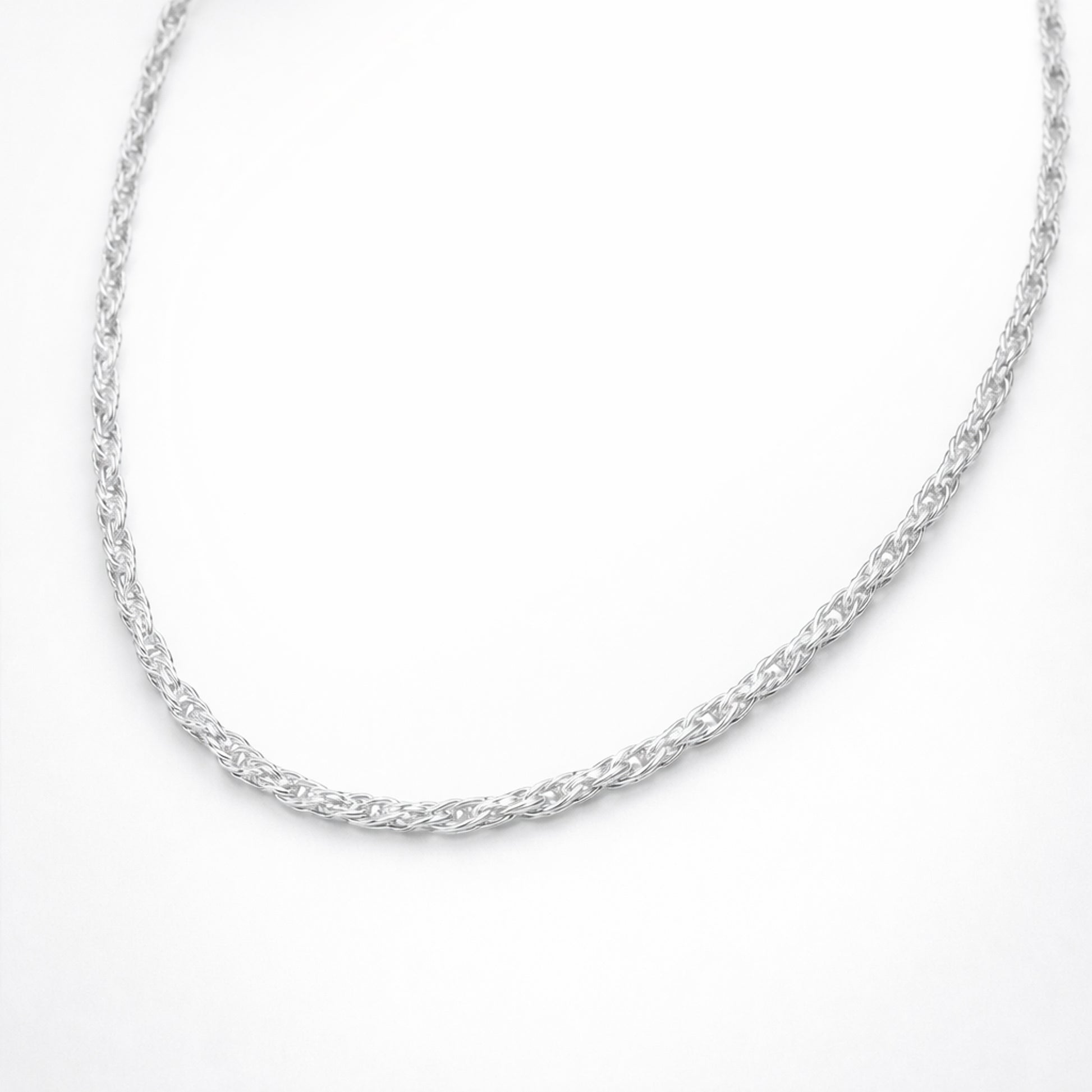 Angled studio view of the twisted chain necklace emphasizing the braided twist structure, depth, and polished silver tone finish.