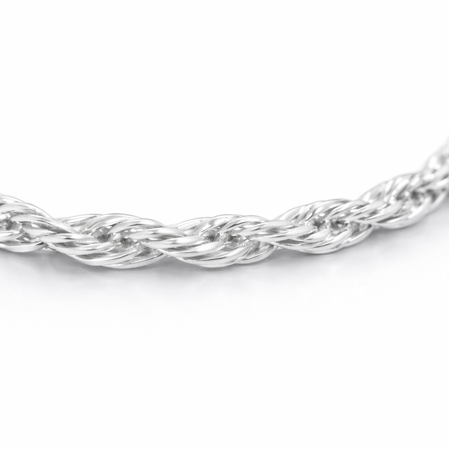 Close up detail of the twisted chain necklace focusing on the intertwined strands and smooth polished silver tone surface.