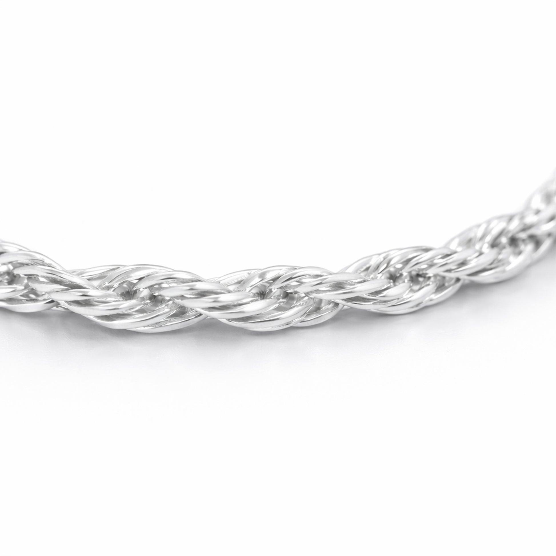 Close up detail of the twisted chain necklace focusing on the intertwined strands and smooth polished silver tone surface.
