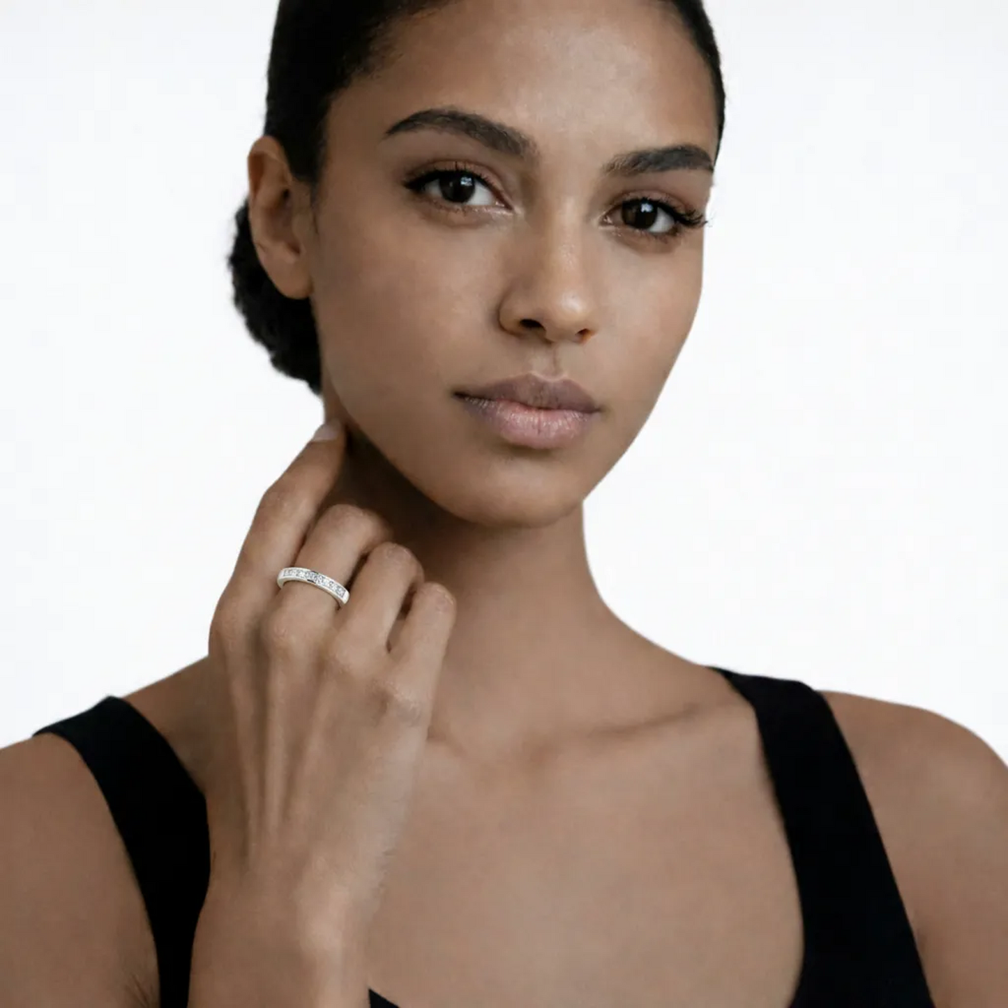 On-model portrait highlights a diamond style rings with cubic zirconia, styled with a black sleeveless top so the ring sparkles along the fingertips.
