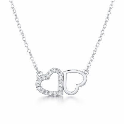 Front facing studio view of the double heart cubic zirconia pendant featuring one pavé set heart alongside one open heart in a balanced design.