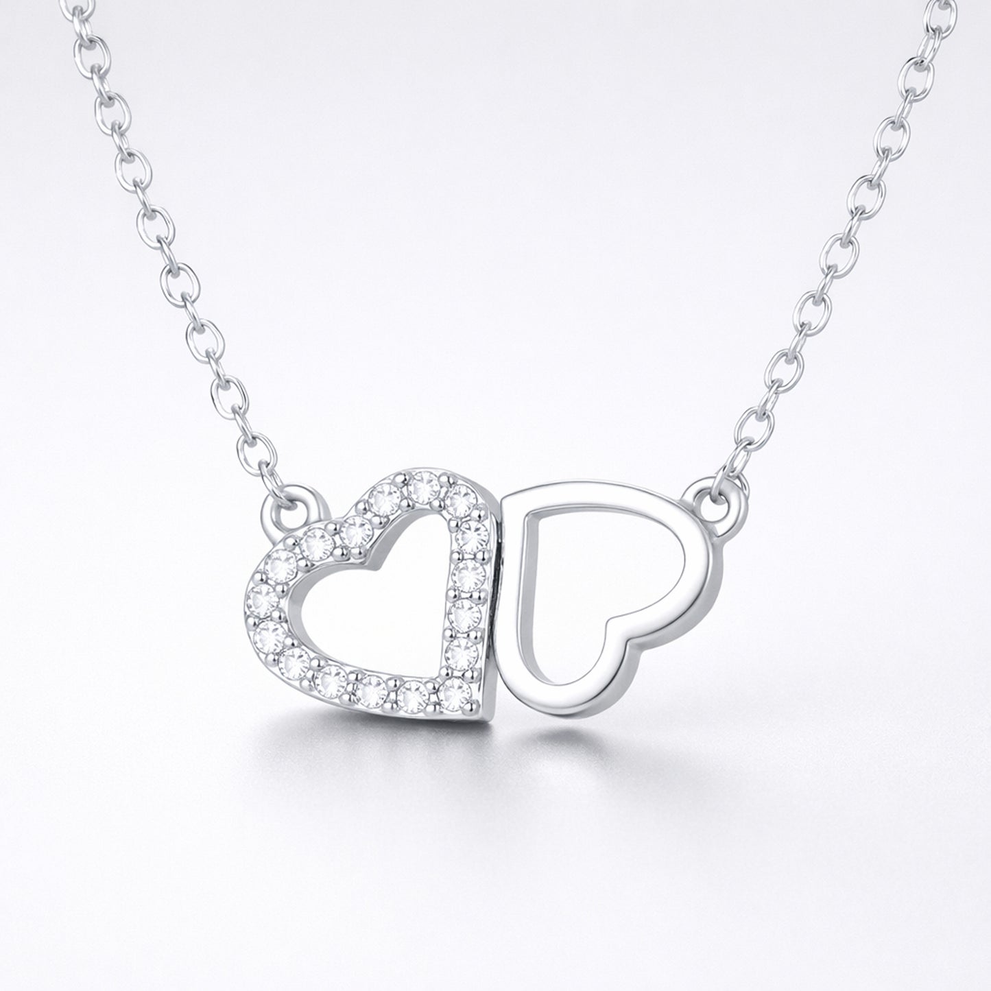 Studio view of the double heart cubic zirconia pendant centered to show the balanced heart design.