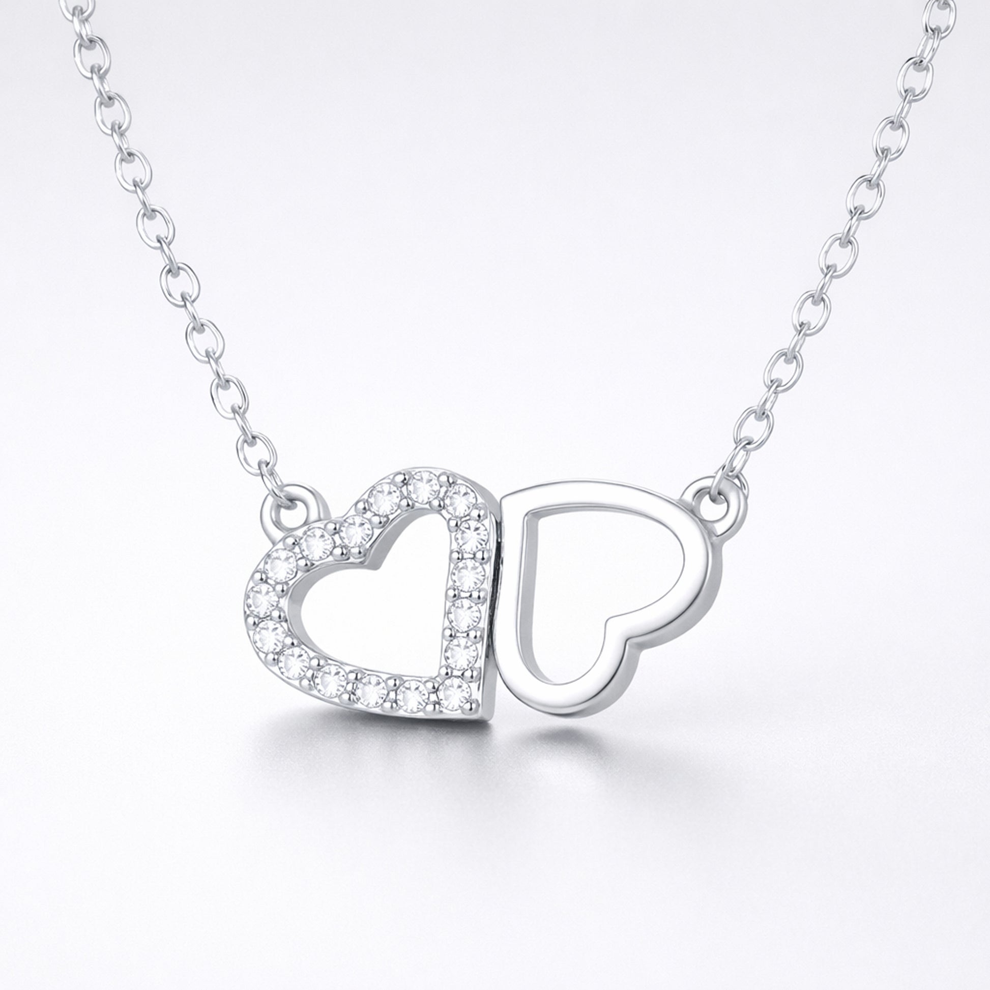 Studio view of the double heart cubic zirconia pendant centered to show the balanced heart design.