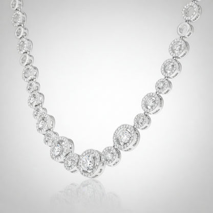 Angled studio view of a halo style silver tone necklace emphasizing the symmetrical stone arrangement.