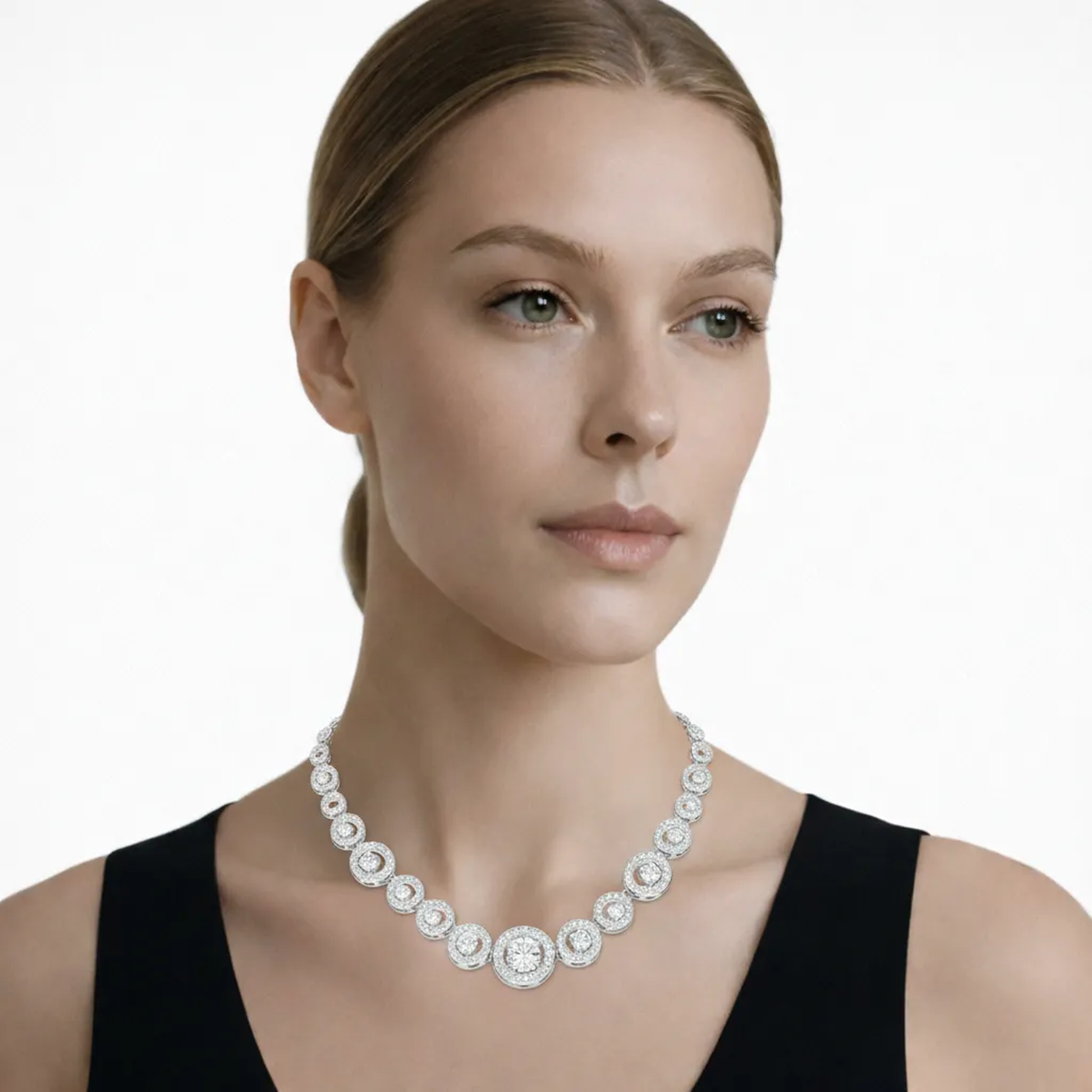 Model view showcases a silver tone halo style cubic zirconia necklace, styled with a minimalist black top so the chain drapes cleanly along the collarbone.