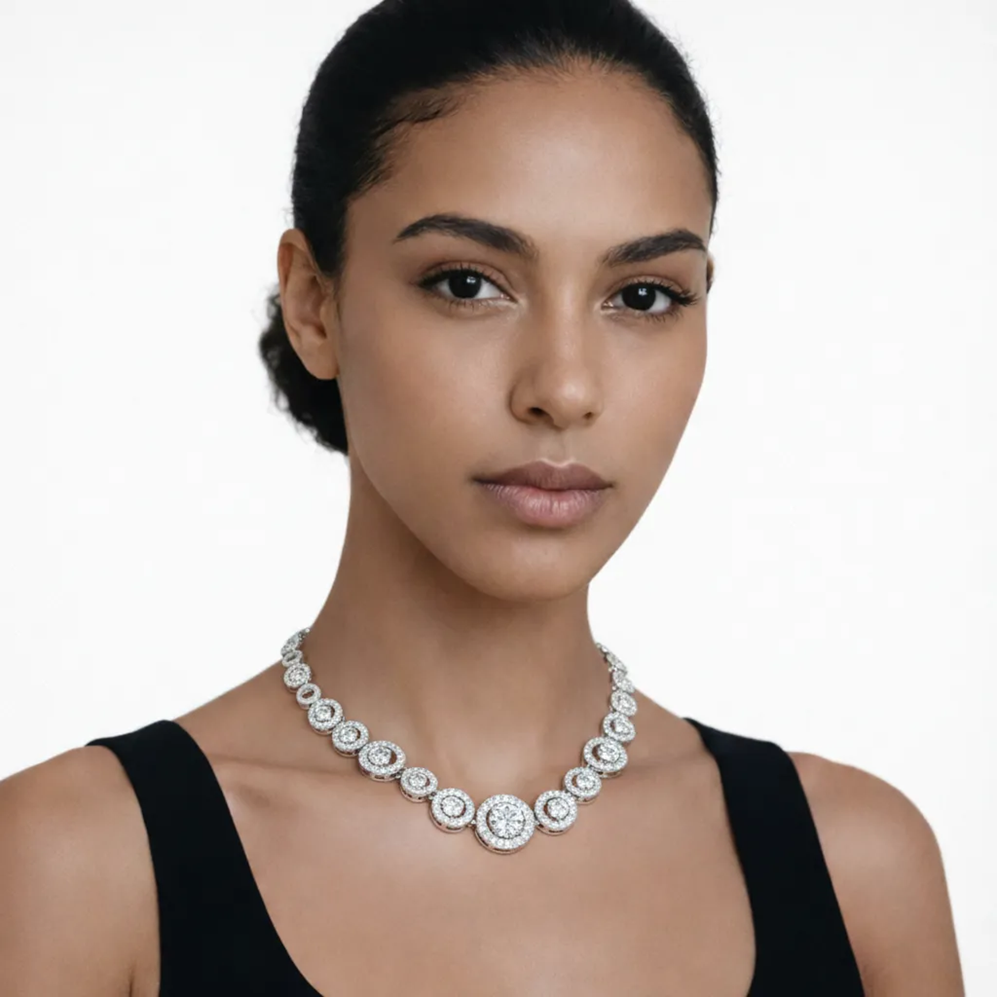On-model portrait highlights a halo style cubic zirconia necklace, styled with a black tank neckline so the chain drapes cleanly along the collarbone.