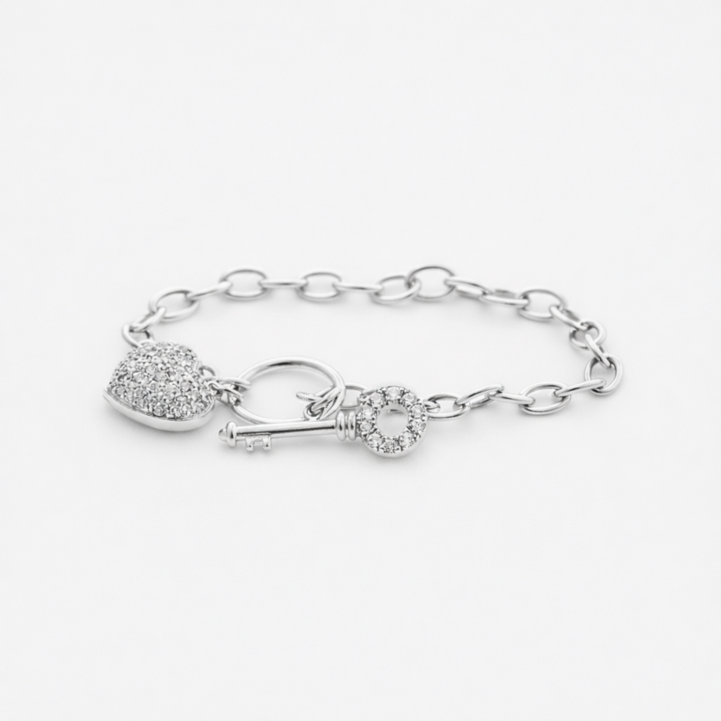 Studio image showing the full heart and key charm bracelet in silver tone with detailed chain design.