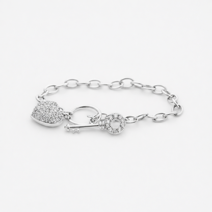 Studio image showing the full heart and key charm bracelet in silver tone with detailed chain design.