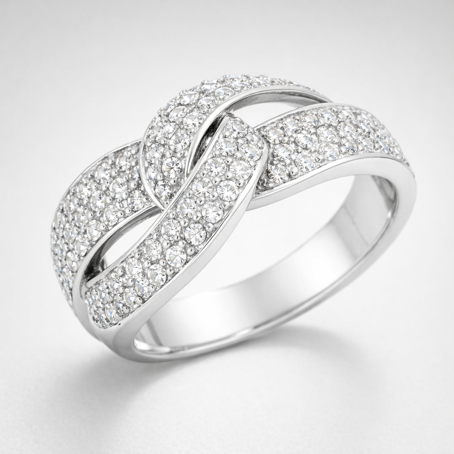 Angled view of the infinity pavé cubic zirconia ring highlighting the crossing design and continuous pavé setting.
