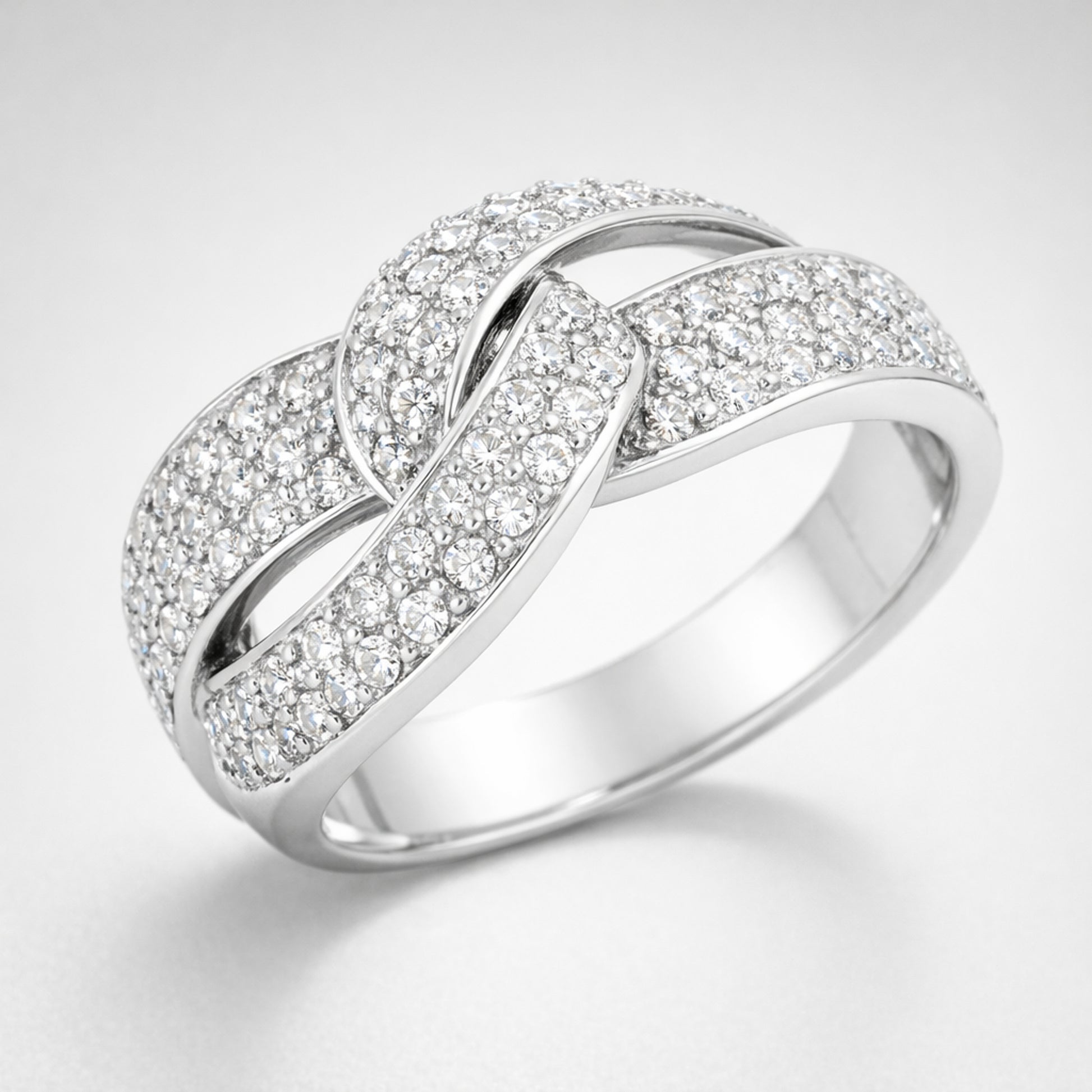 Angled view of the infinity pavé cubic zirconia ring highlighting the crossing design and continuous pavé setting.