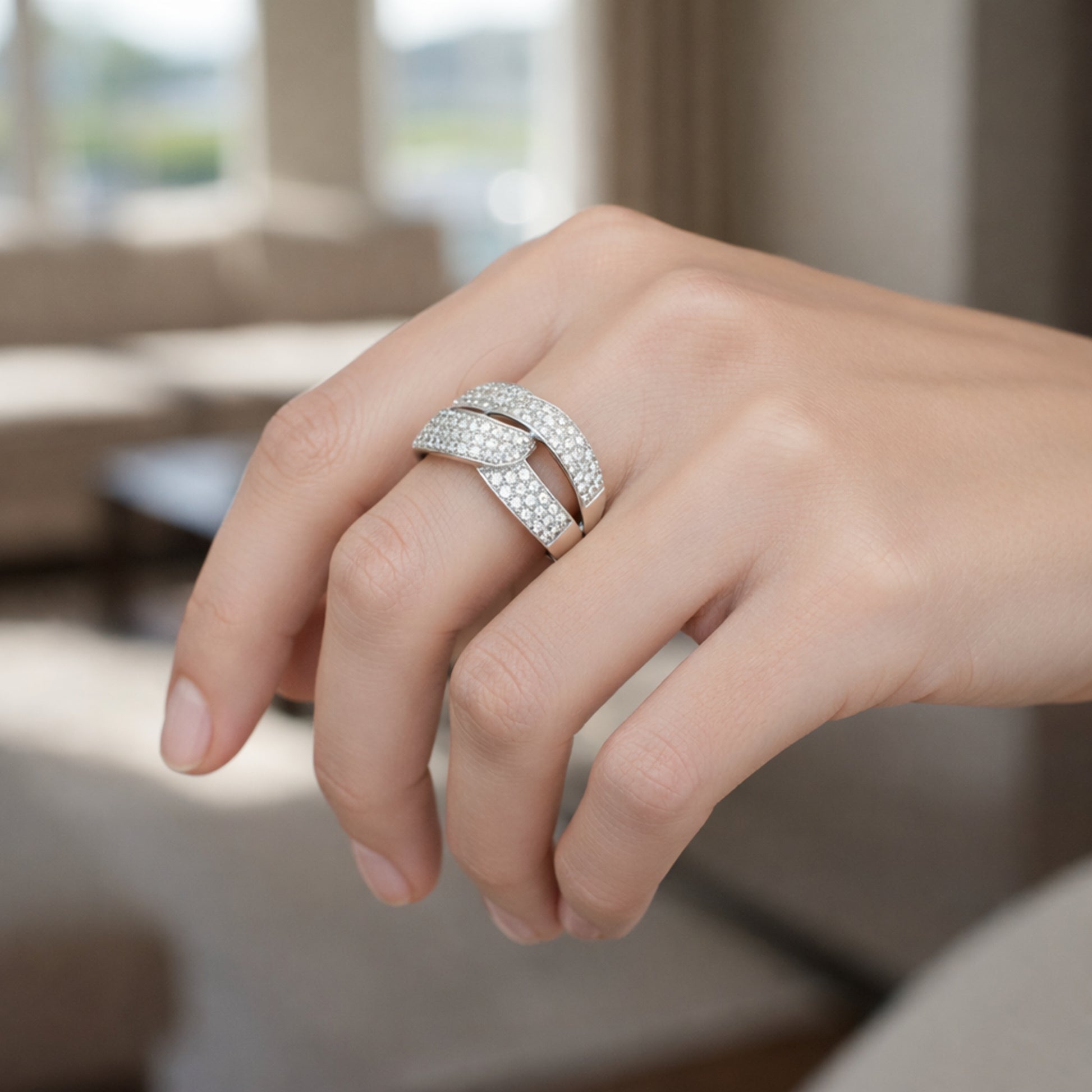 Worn view of the infinity pavé cubic zirconia ring in silver tone finish, showing how the interlaced design sits on the finger.