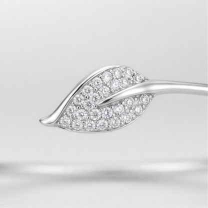 Close up view of the open cuff bracelet showing smooth curves and cubic zirconia detailing.