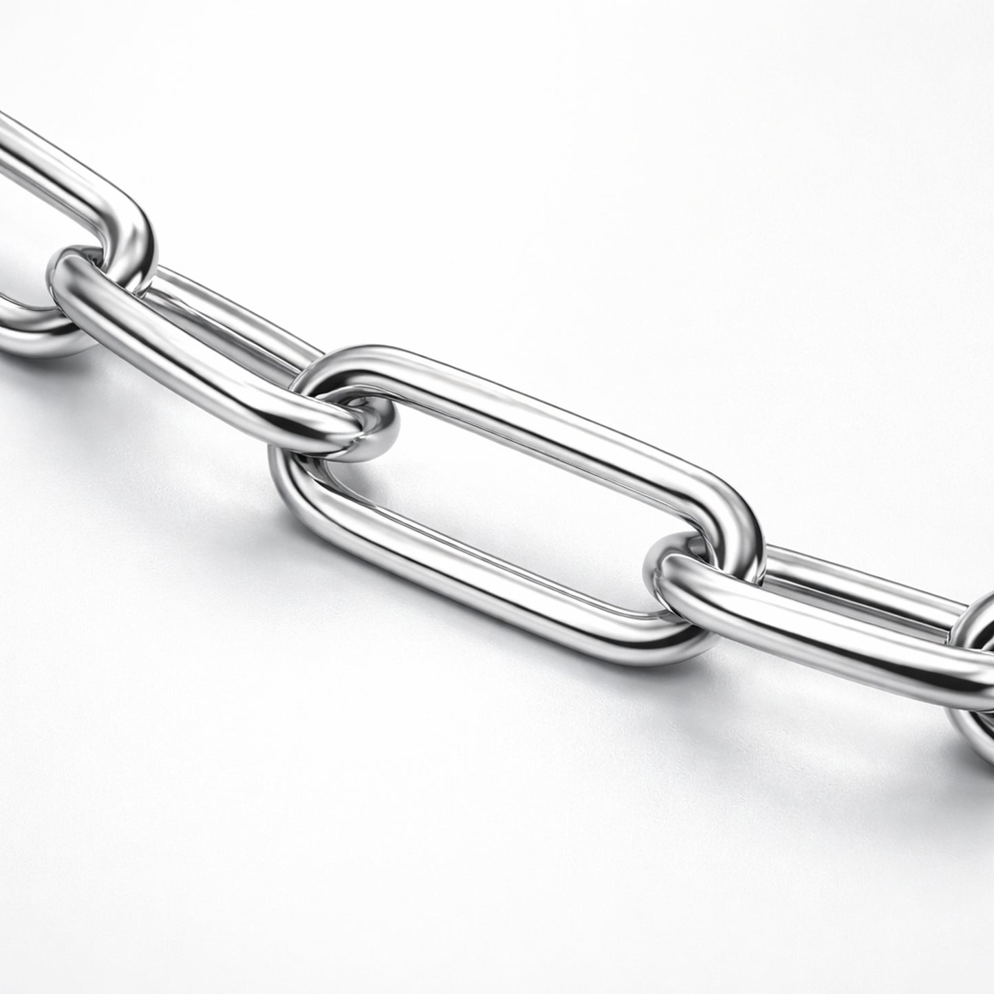 Close up studio image highlighting the elongated paperclip links of a silver tone chain necklace with a polished finish.