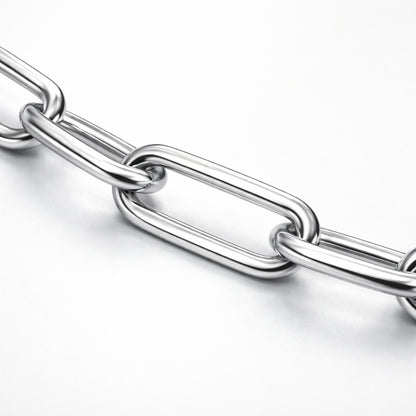 Close up studio image highlighting the elongated paperclip links of a silver tone chain necklace with a polished finish.