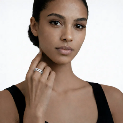 On-model portrait highlights a silver tone pav chain link cubic zirconia ring, styled with a black sleeveless top so the ring sparkles along the fingertips.