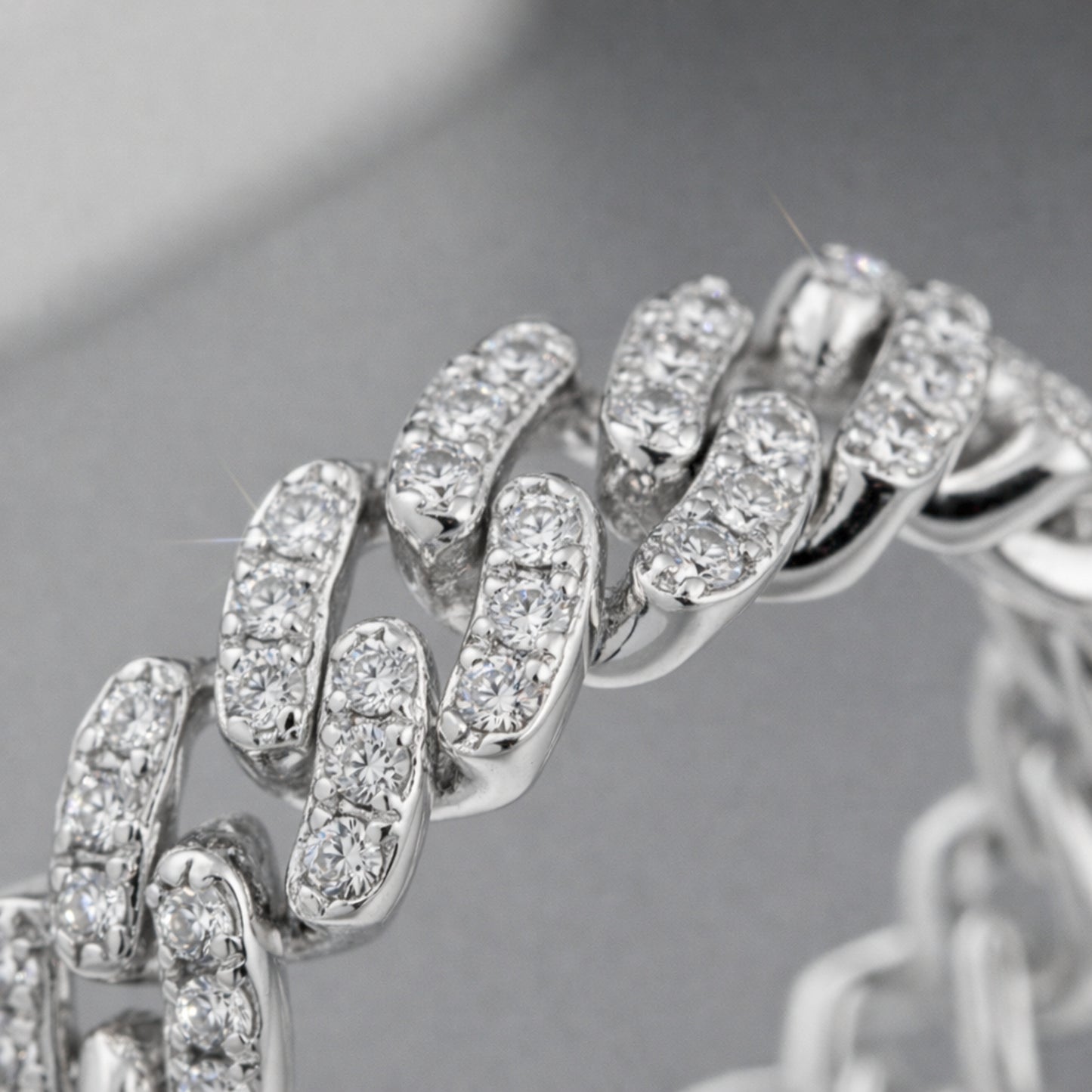 Angled studio view of the pavé chain link cubic zirconia ring showing the polished links and pavé detailing.