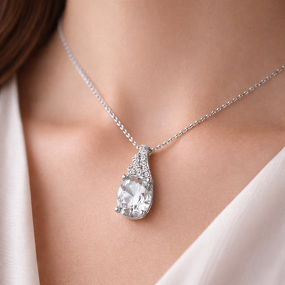 Worn view of the pear cut cubic zirconia pendant highlighting the depth of the setting and polished silver tone finish.