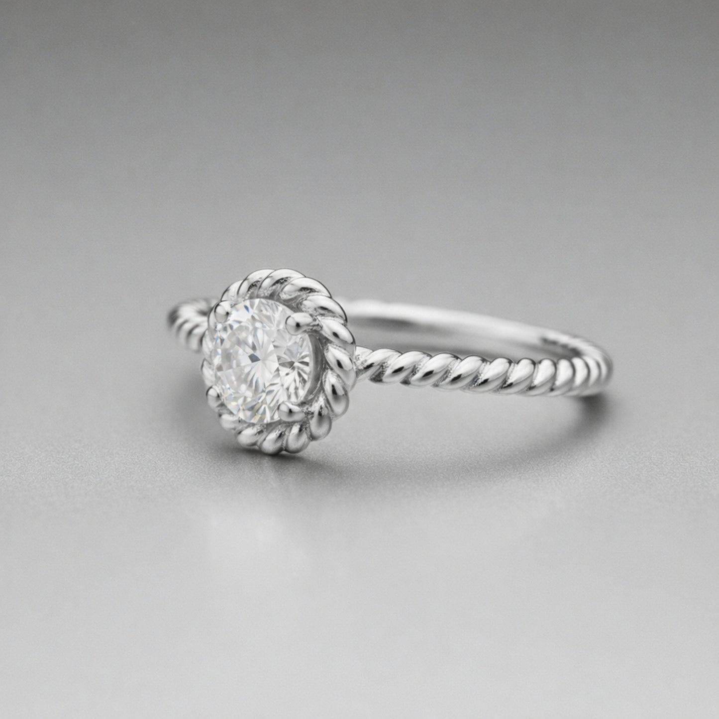 Angled view of the rope style solitaire cubic zirconia ring showing the raised solitaire setting and twisted shank design.
