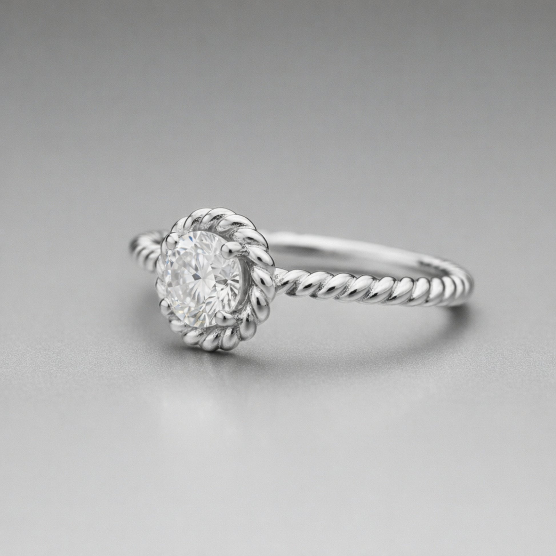 Angled view of the rope style solitaire cubic zirconia ring showing the raised solitaire setting and twisted shank design.