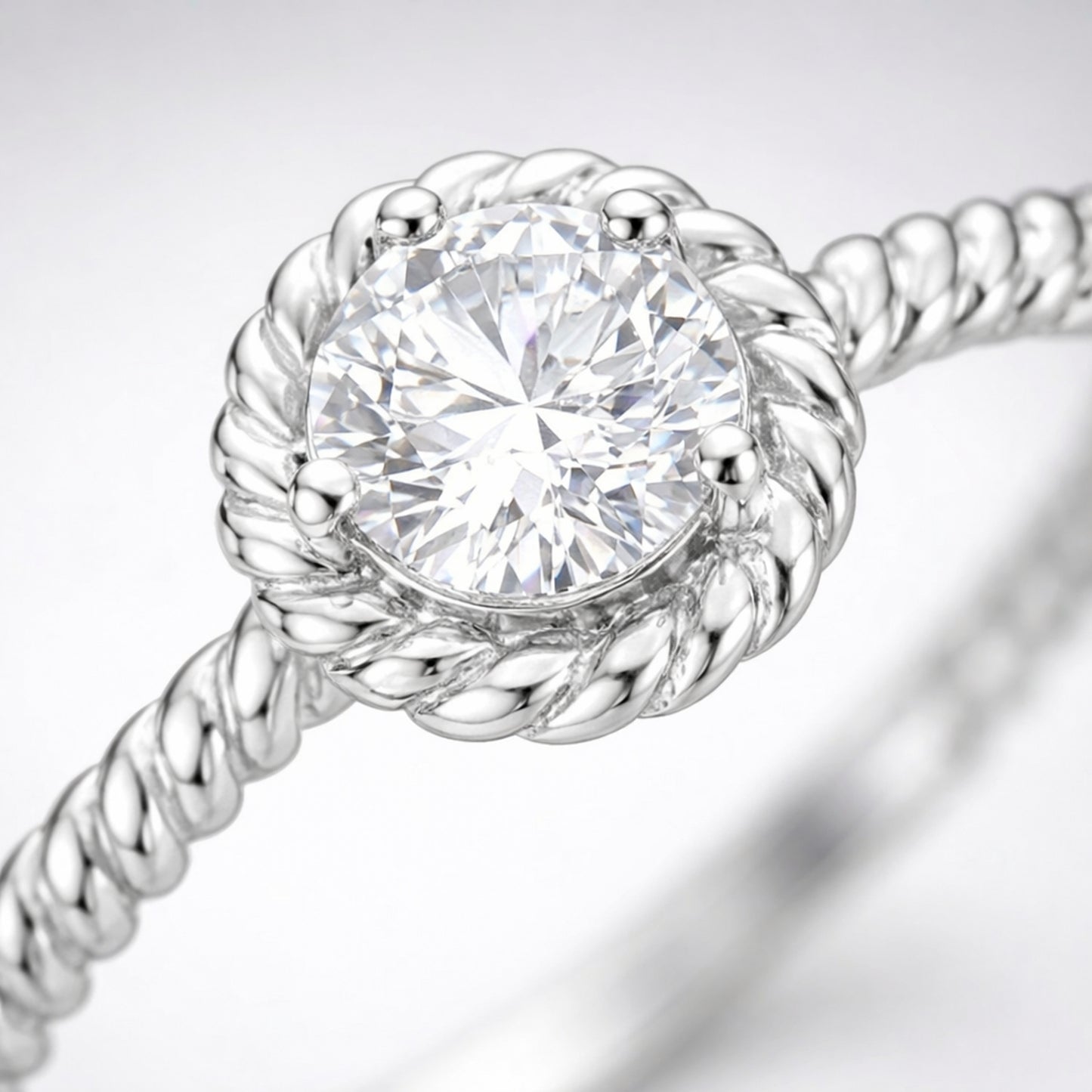 Close up view of the rope style solitaire cubic zirconia ring highlighting the twisted band texture and round center stone.