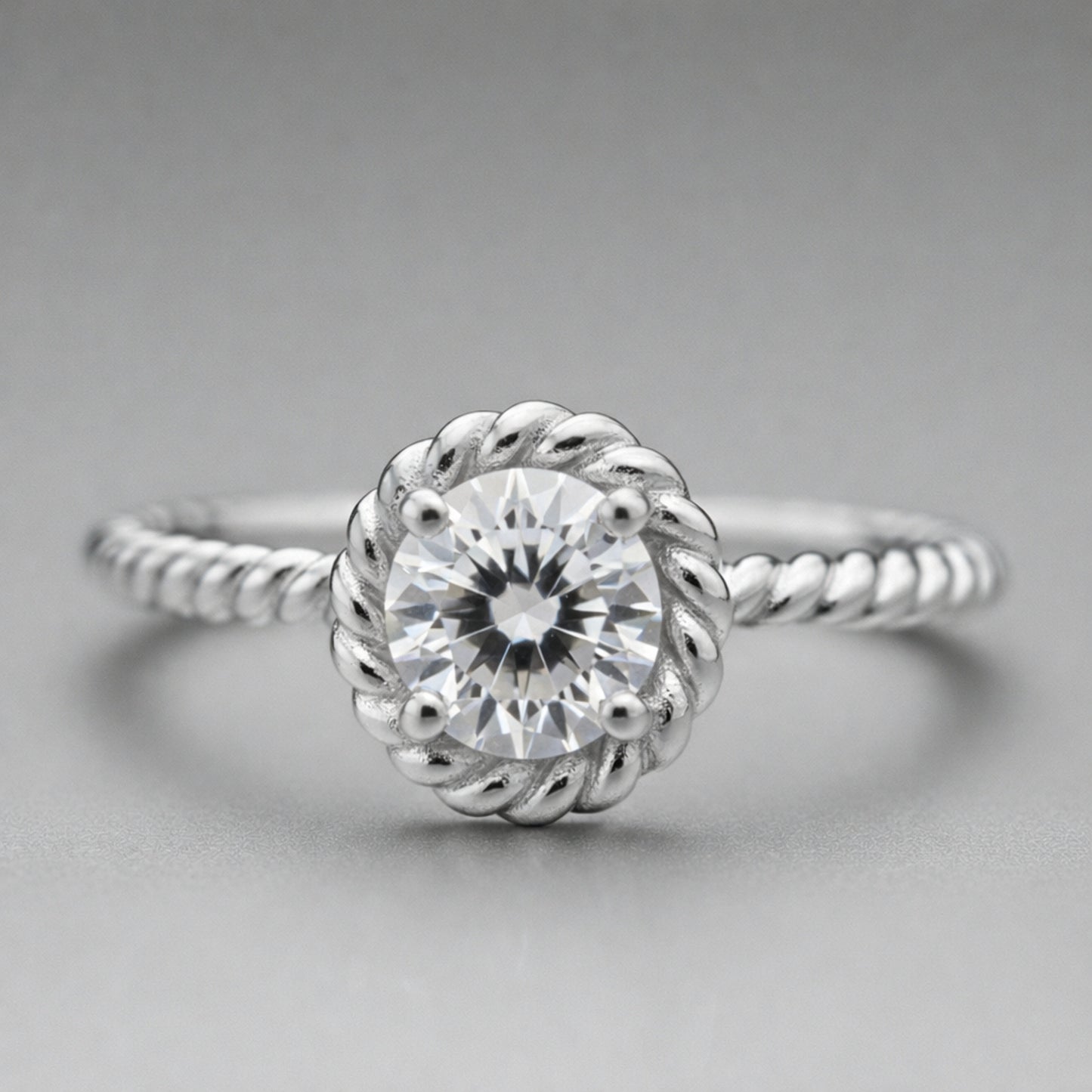 Front facing view of the rope style solitaire cubic zirconia ring showcasing the round center stone in a decorative rope style setting.