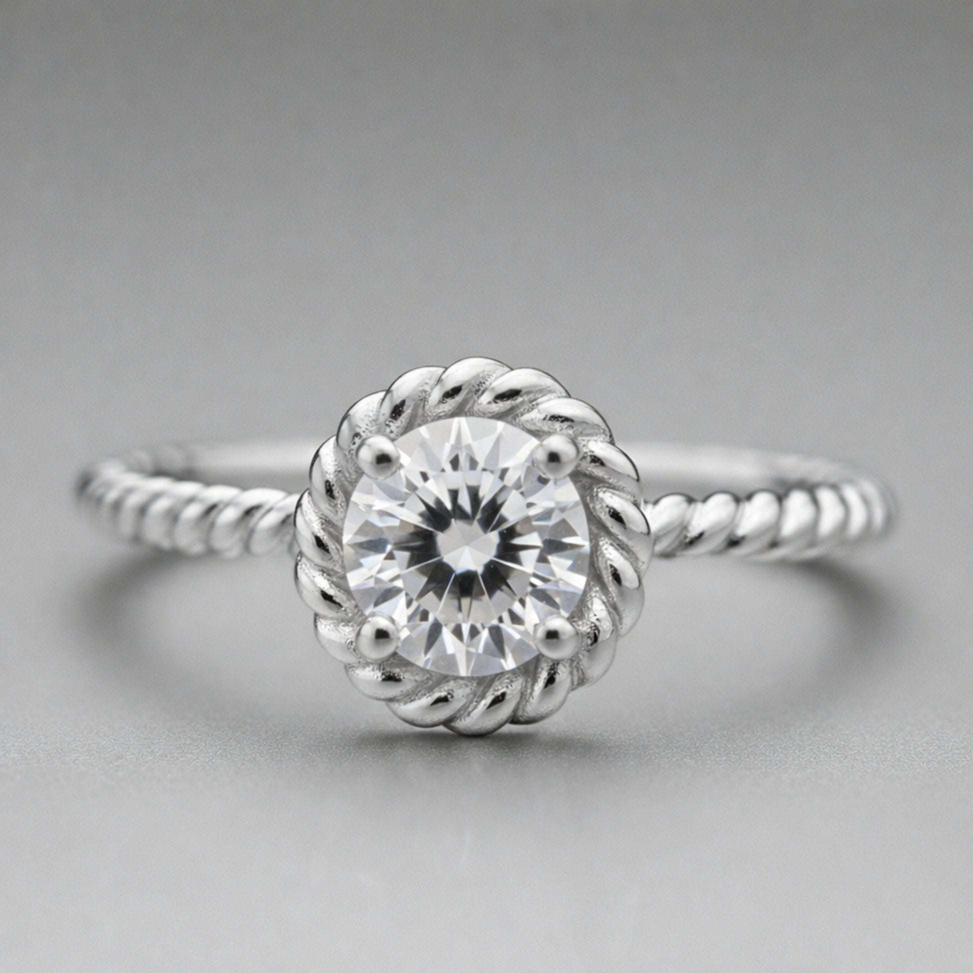 Front facing view of the rope style solitaire cubic zirconia ring showcasing the round center stone in a decorative rope style setting.
