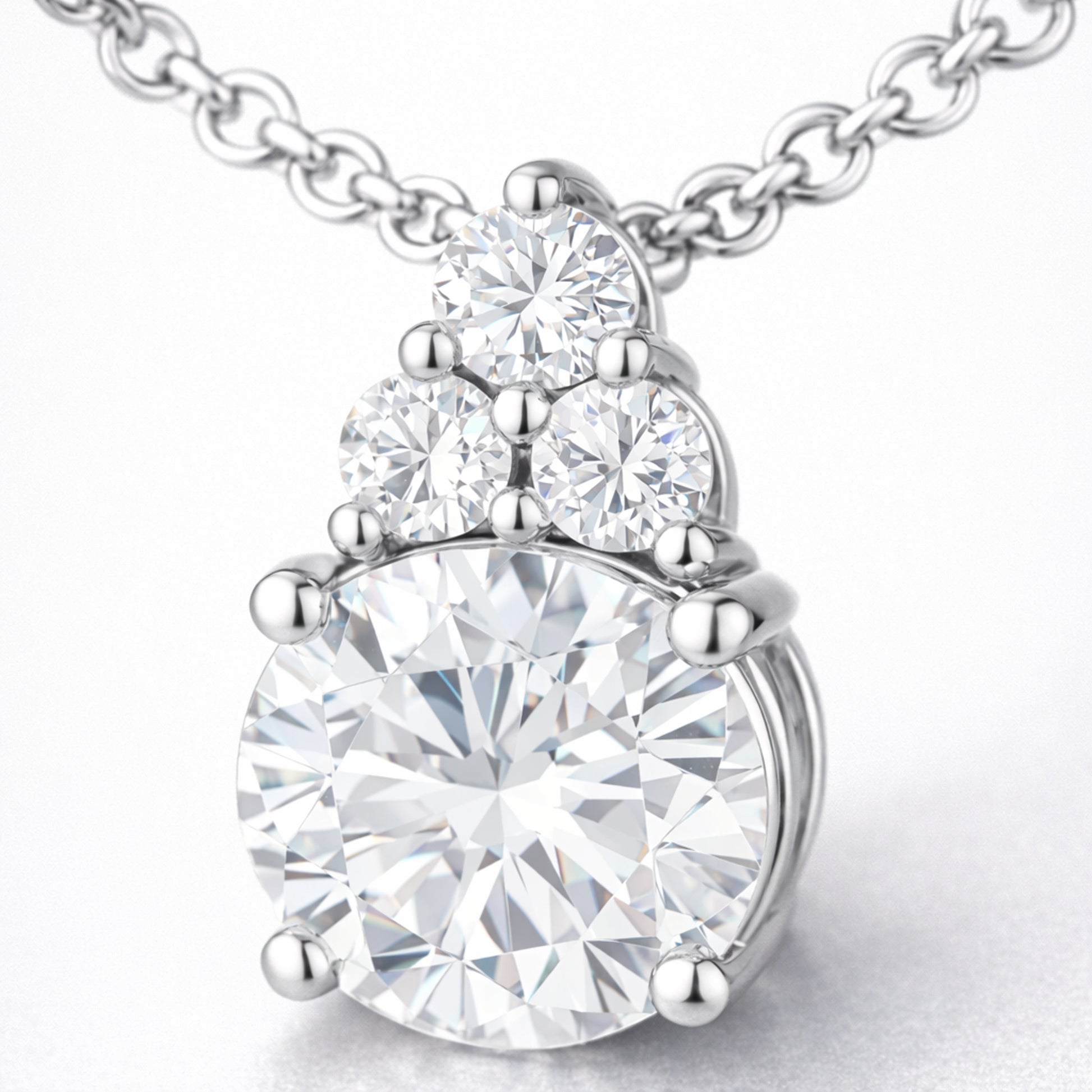 Close up detail of the round cut cubic zirconia pendant focusing on the prong setting accent stones and polished finish.