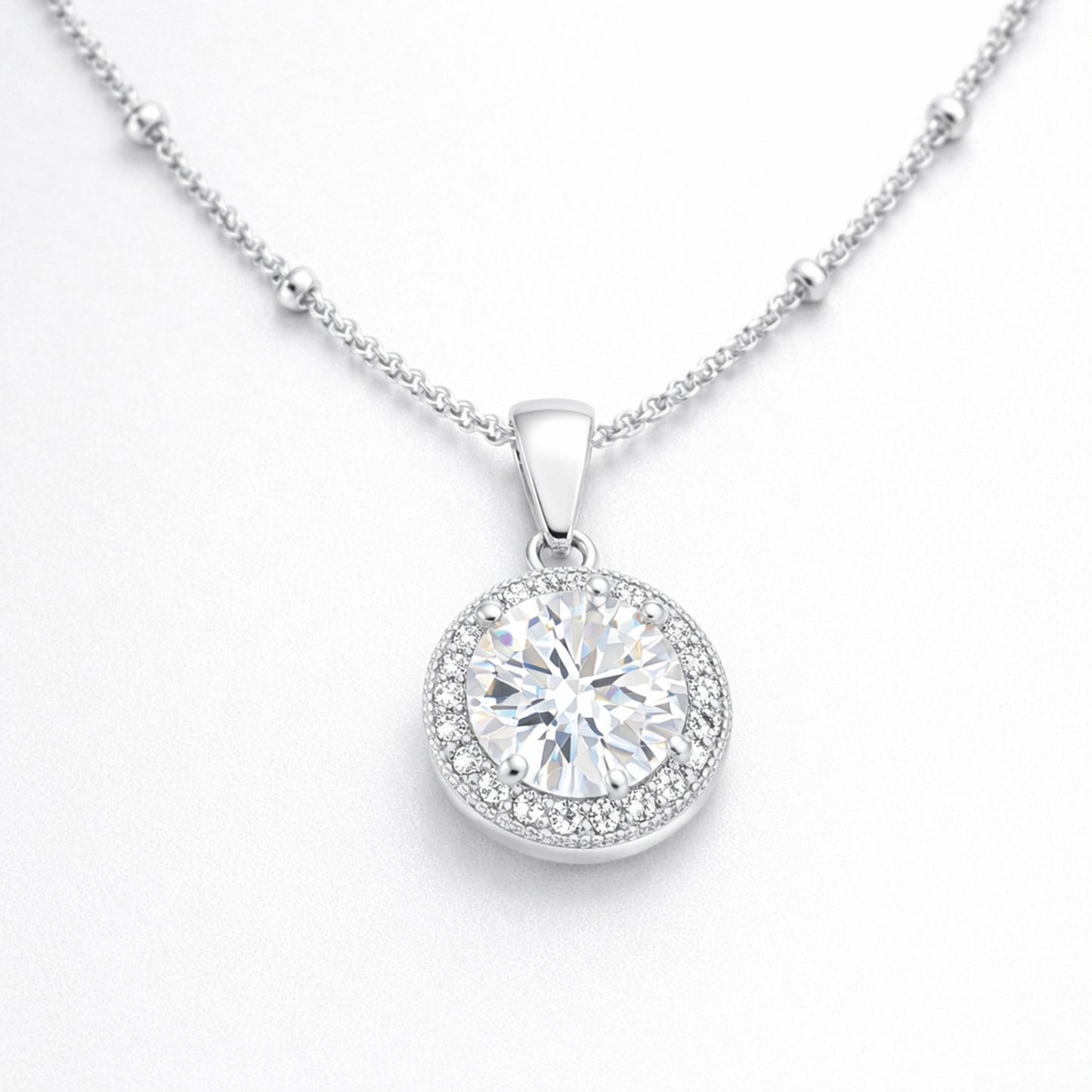 Angled studio view of the round halo pendant highlighting the prong set center stone and surrounding cubic zirconia halo.