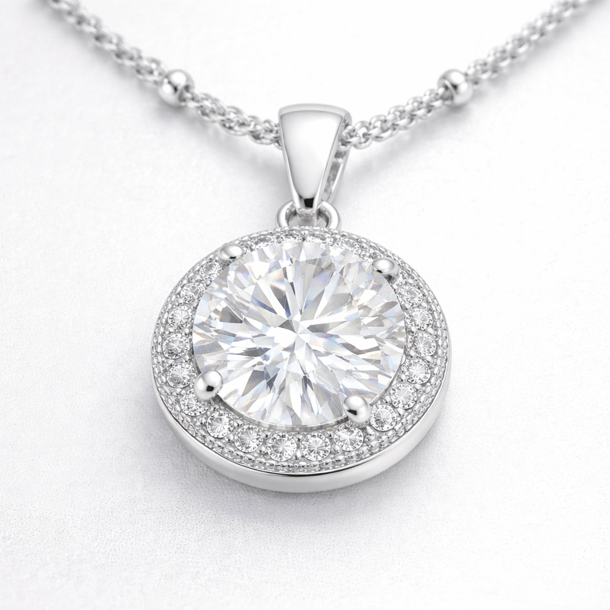 Close up view of the round halo cubic zirconia pendant focusing on the stone facets and detailed halo setting.