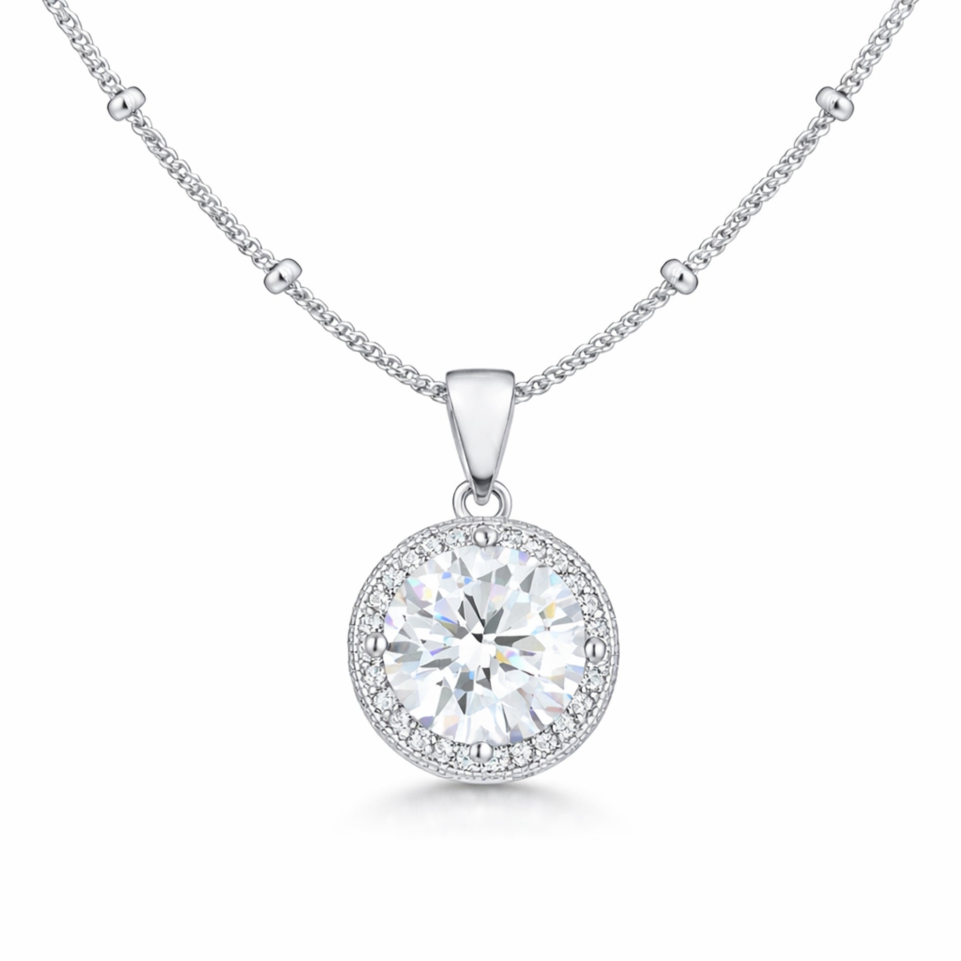 Studio view of a round halo pendant featuring a central cubic zirconia stone surrounded by a halo of smaller stones in silver tone.