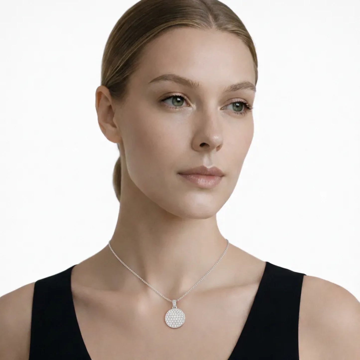 Model view showcases a silver tone round pav cubic zirconia pendant, styled with a sleek black top so the pendant stays centered at the neckline.