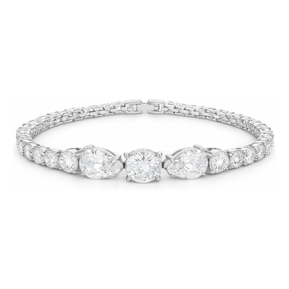 Studio view of a tennis bracelet featuring a central three-stone arrangement with larger cubic zirconia stones, surrounded by a row of smaller stones in silver tone.