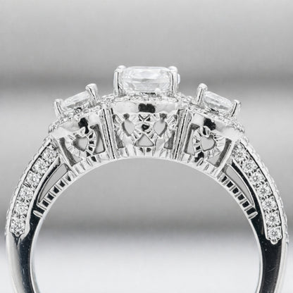 Side profile view of the three stone halo cubic zirconia ring highlighting the gallery details and pavé set shoulders.

